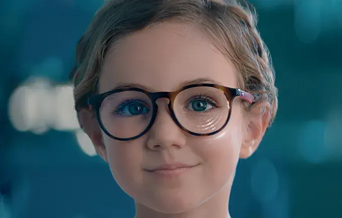 Young girl wearing Essilor Stellest glasses lenses. 