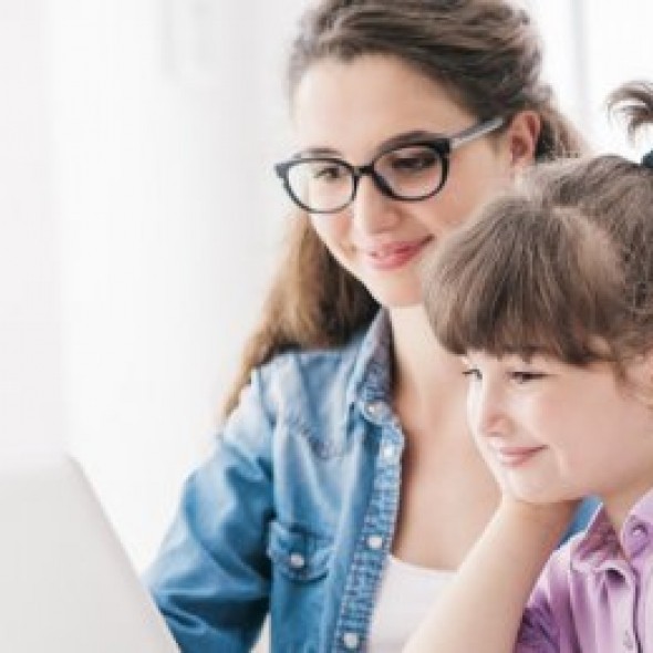 Mother and daughter reading from computer screen