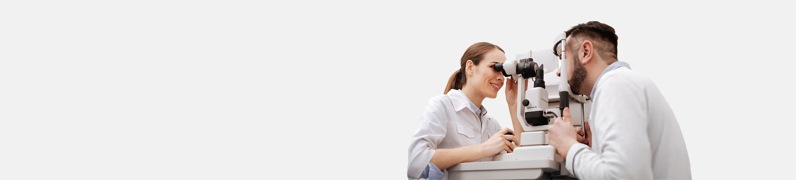 optician performing an eye exam to a patient