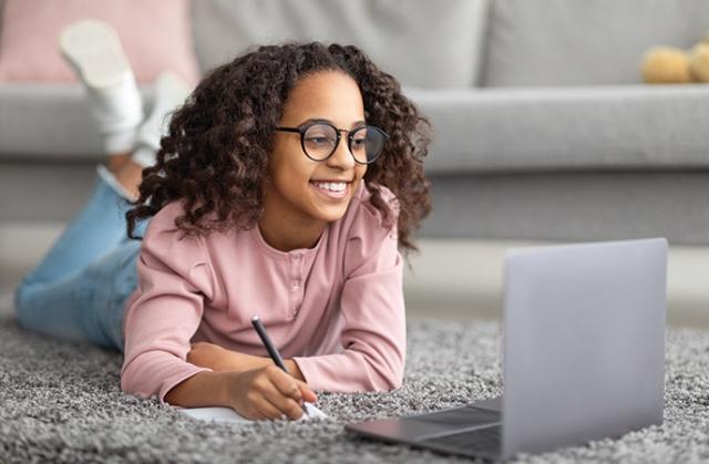 Young girl with glasses on laptop