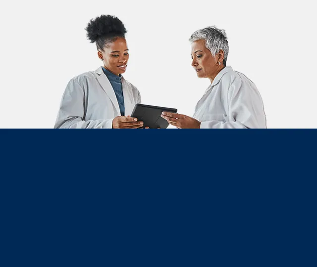 Two optometrists are discussing a patient’s treatment plan.