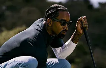 Male playing golf wearing Oakley Performance AI Meta glasses.