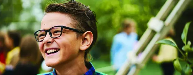 Male child wearing glasses outdoors