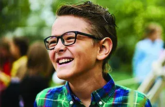 Male child wearing glasses outdoors