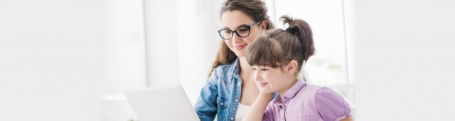 Mother and daughter reading from computer screen