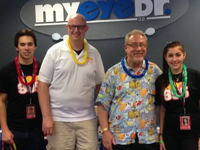four people smiling at the camera