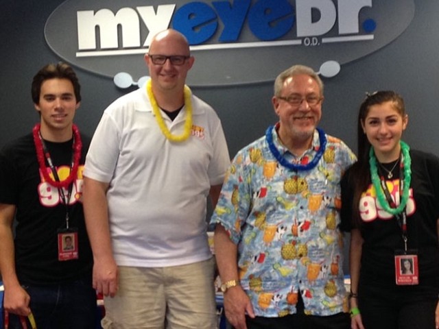 four people smiling at the camera
