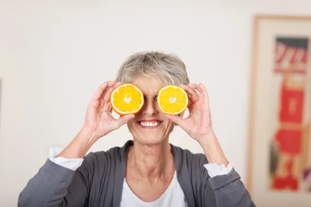 Older lady with oranges over her eyes