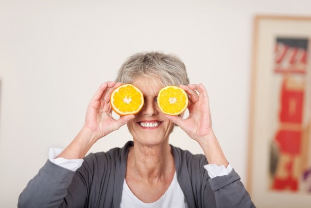 Older lady with oranges over her eyes