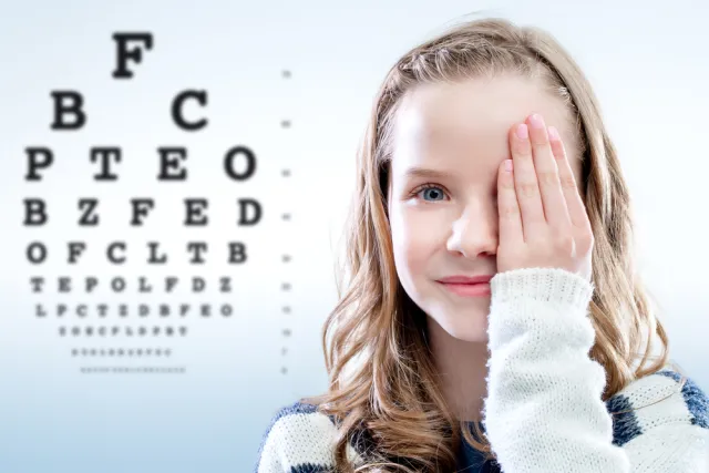 young girl performing eye test