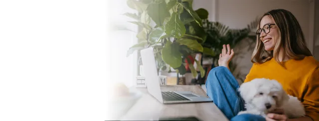 Woman on video chat with dog in her lap