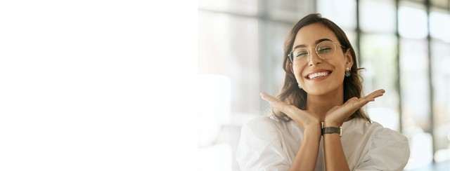 Woman smiling with her hands under her face