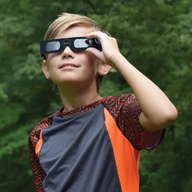 Boy wearing solar eclipse glasses