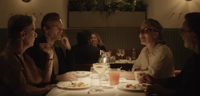 People seated in a restaurant wearing Nuance Audio Glasses.