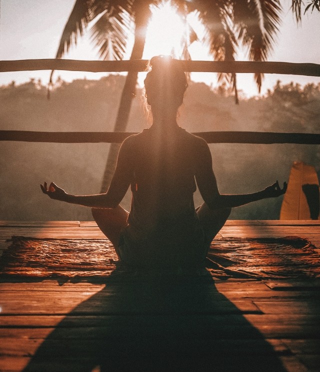 woman meditating in lotus pose